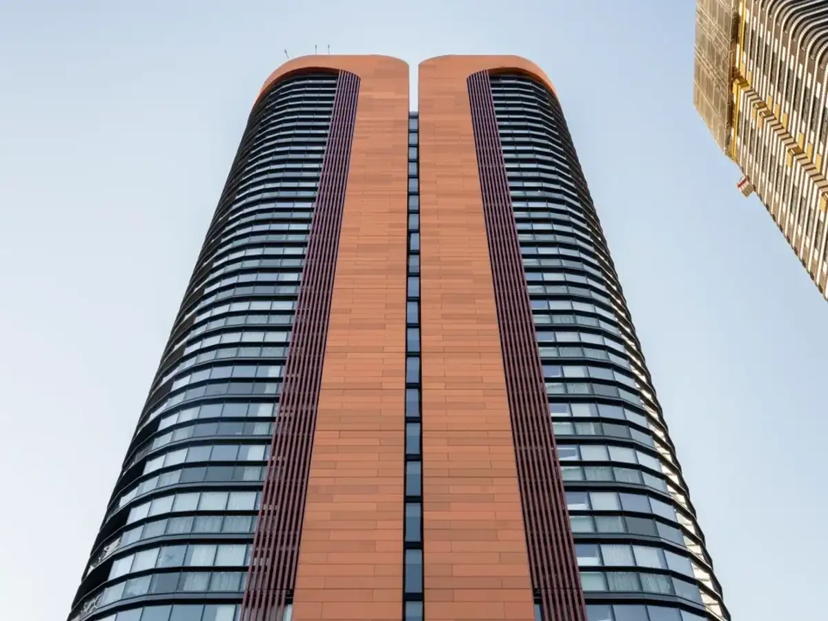 A twin-tower residential building seen from street level